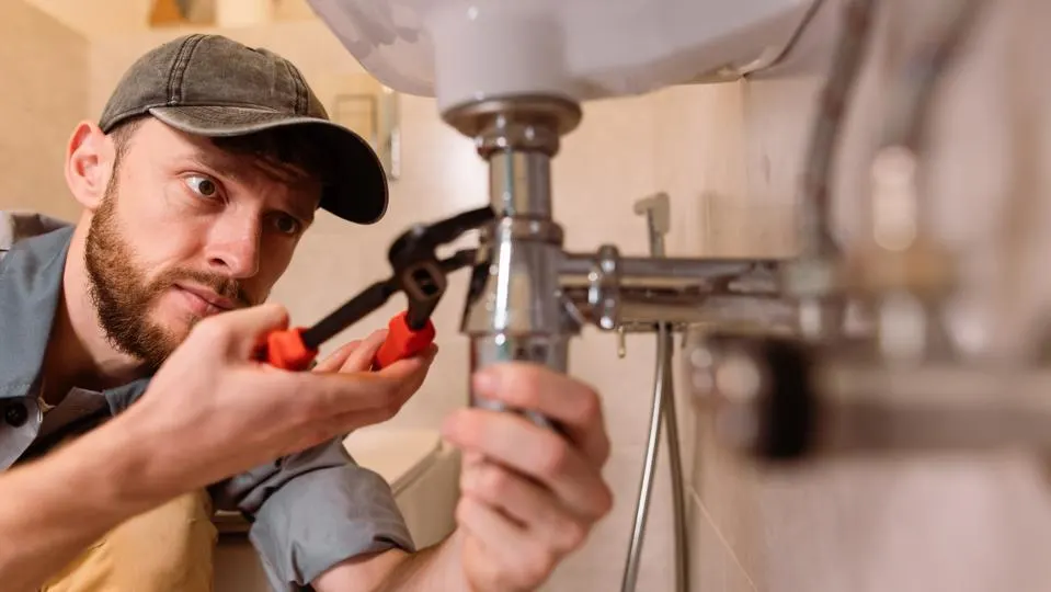 plumber unblocking drain hero